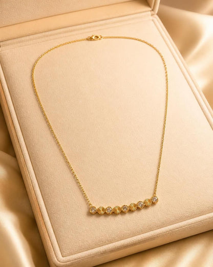Solara Crystal Sunburst gold-tone stainless steel necklace with alternating crystal and textured disc accents
